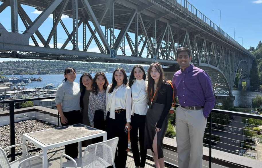 Capstone team photo on rooftop terrace with bridge in background