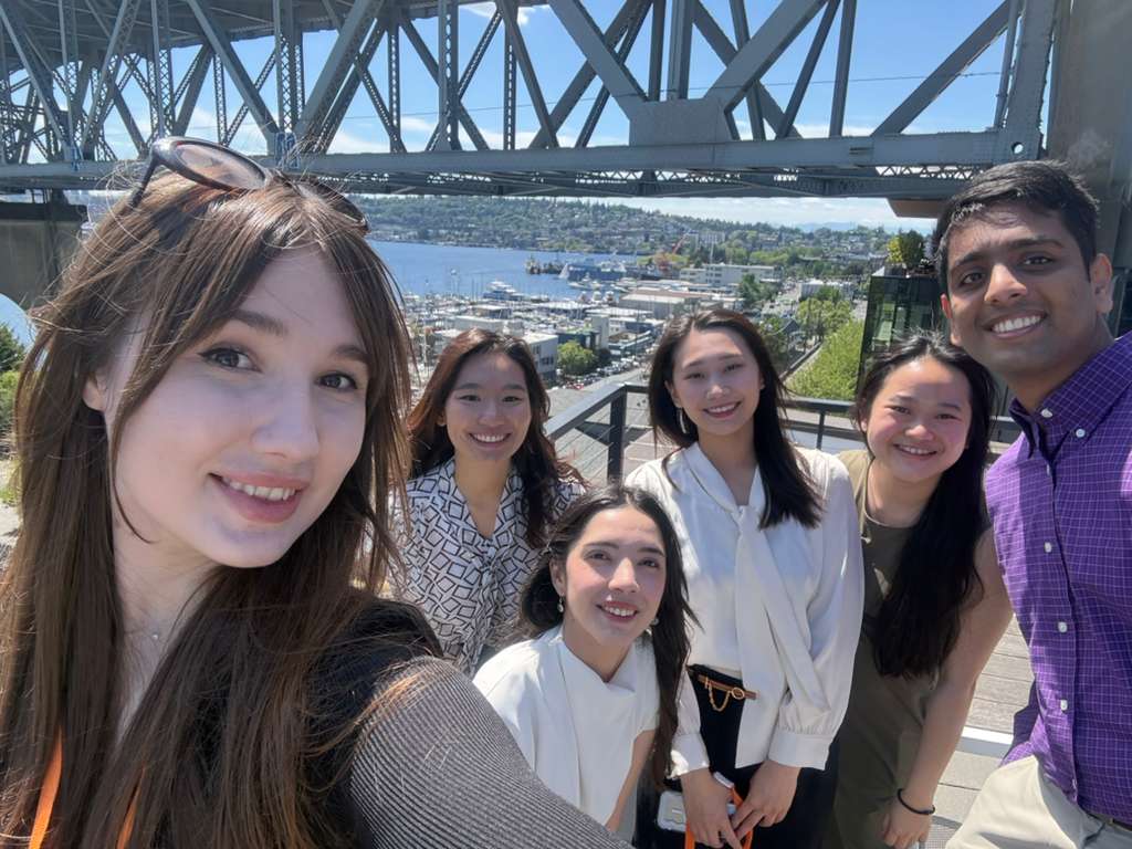 Capstone team selfie outdoors with bridge and waterfront